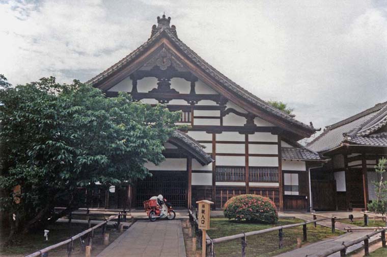 KYOTO: Founded in 1605 in memory of Toyotomi Hideyhoshi by his widow Kito no-Mandokoro. A relatively quiet scene, except for this fellow parking his scooter near the entrance. May 14, 1998