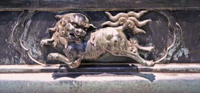NARA: This Chinese-style lion decorates the base of a lantern in front of one of the buildings in the complex. May 21, 1998