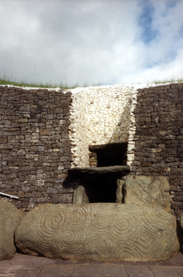 Brú na Bóinne: Although these clearly served as burial mounds, some of them like Newgrange obviously had other ceremonial uses. Above the entry door was found a shaft which admits a beam of light to illuminate the central chamber only at dawn on the winter solstice (if the weather happens to be clear--no sure thing!). Because of the precession of the equinoxes, the illumination is a little off in modern times, but the alignment is still quite close. The restoration of the facade around the entrance is controversial, having been created by archeologists making guesses based on rubble in the 1960s. It's striking, but seems implausible. Visitors are taken inside the central chamber, which is awe-inspiring (photography forbidden).