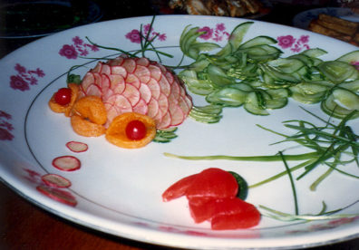 . . . including this fish carved out of vegetables, blowing radish-slice bubbles.
