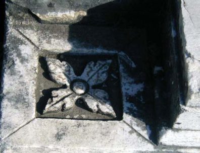 ASCLEPION: Floral decorations in various designs are scattered on marble fragments nearby.