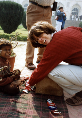 Paula Elliot buying little slippers made of cigarette wrapper foil. Tour leader Fritz Blackwell said he had bought identical ones from a similar little girl a generation ago, perhaps her mother.
