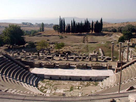 ASCLEPION: The raised stage is new, but the backdrop fragments (the scaena) are original.