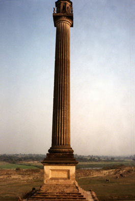 A gigantic classical column built for decorative purposes by wealthy eccentric Major General Claude Martin (d. 1800). To get a sense of its size, note the cattle grazing nearby on the left.