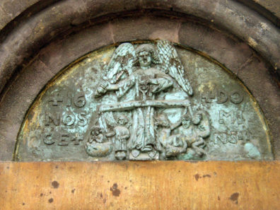 BUDAPEST: The carving over the door shows an angel, rather than the usual figure of Christ, weighing out the sins of humanity at the Last Judgment. Note the demon at work on the angel's left (your right), where the damned are always located.