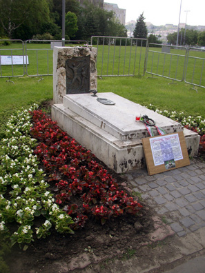 BUDAPEST: Text of sign: Memorial of the 1956, Budapest. This memorial is a symbolic grave. Here, on this square, several hundreds of people fell dead onto the ground due to the killer blows of a firing squad on October 25, 1956. Honour on remembrance to the victims!
