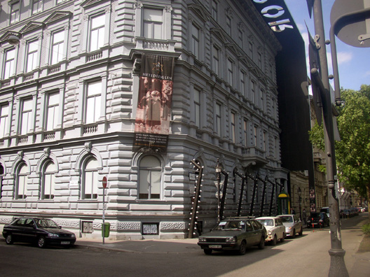 BUDAPEST: A much more serious approach to the memory of the Communist era is taken in the powerful House of Terror on Andrassy Boulevard. There is an exhibit about the Hungarian Facsist "Arrow Cross" party and another on Raoul Wallenberg and his rescue of Jews (including many children) from the Nazis; but most of the museum is given over to a powerful series of displays depicting the exiles, tortures, and murders carried out by the Communists. The building, formerly the property of wealthy Jews, was used both by the Arrow Cross and later by the State Secret Police as headquarters. A Soviet tank fills the central atrium. Photography is not allowed.