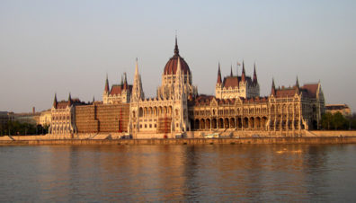 BUDAPEST: Budapest is struggling economically more than Prague, but it has less of the air of a theme park. You're always aware of being in a real, serious city not entirely populated by tourists. View from a tour boat in the middle of the Danube river. The rear of the Parliament building faces the river. On the left is scaffolding for restoration work.