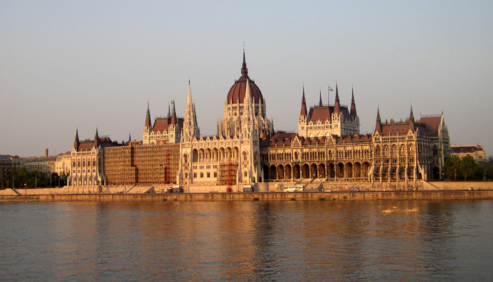 BUDAPEST: Budapest is struggling economically more than Prague, but it has less of the air of a theme park. You're always aware of being in a real, serious city not entirely populated by tourists. View from a tour boat in the middle of the Danube river. The rear of the Parliament building faces the river. On the left is scaffolding for restoration work.