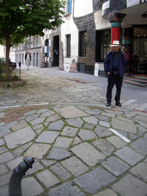 VIENNA: The artist's abhorrence of straight lines is reflected in the curving pavement outside and the comically wilting traffic barriers separating the sidewalk from the street (foreground).