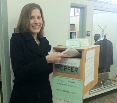 Student dropping bill in hopper.