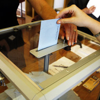 Person putting ballot in box
