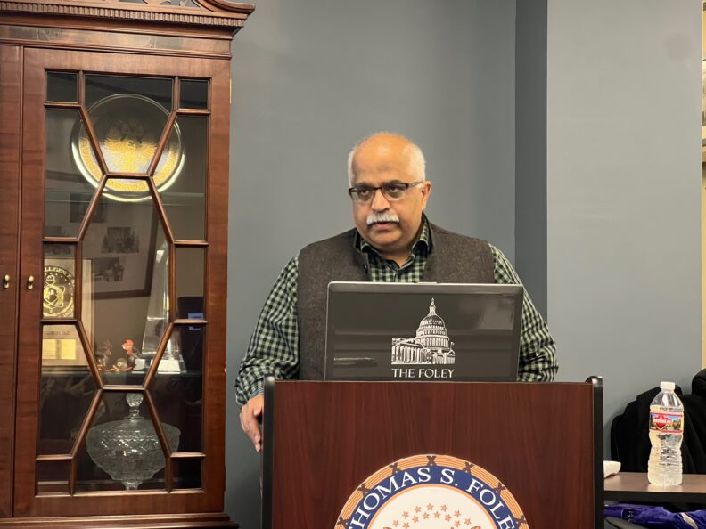 Aseem Prakash at podium. 