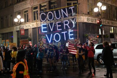 A public demonstration including a sign that reads "Count Every Vote".
