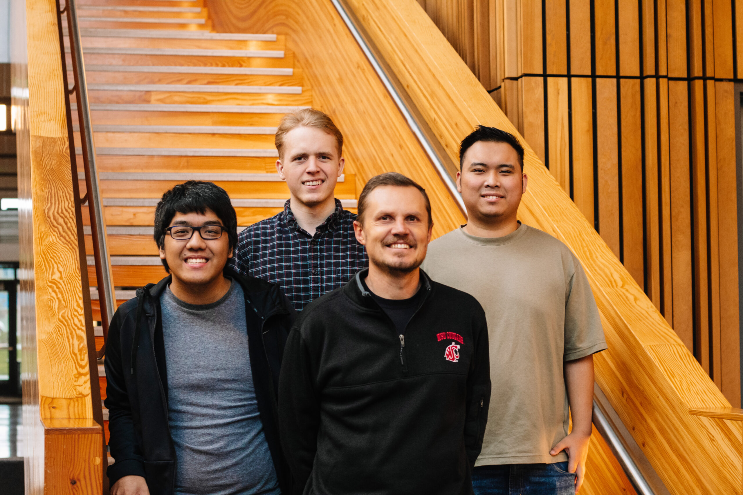 Students and faculty stand in a stairwell.