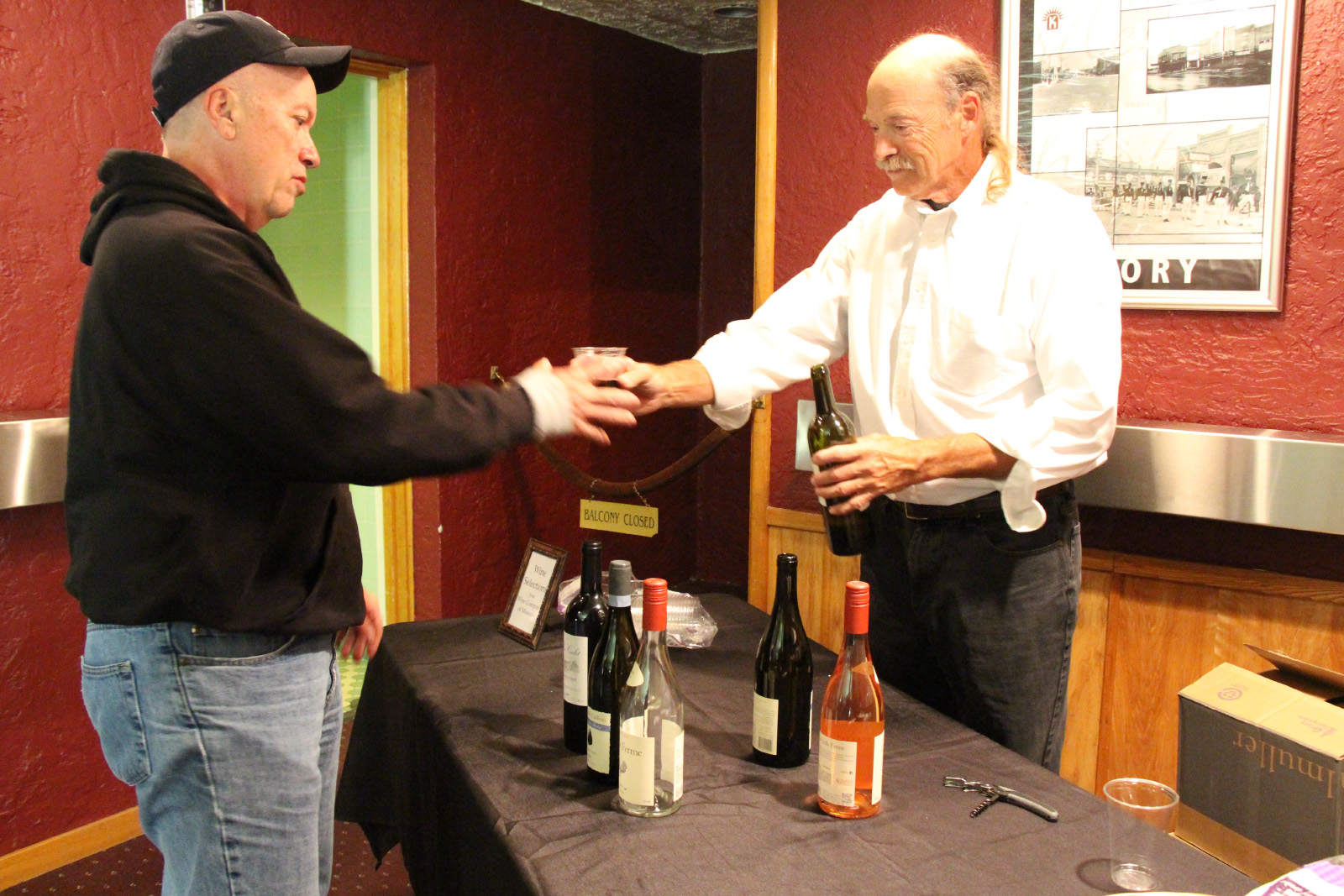 A guest getting a cup of wine.