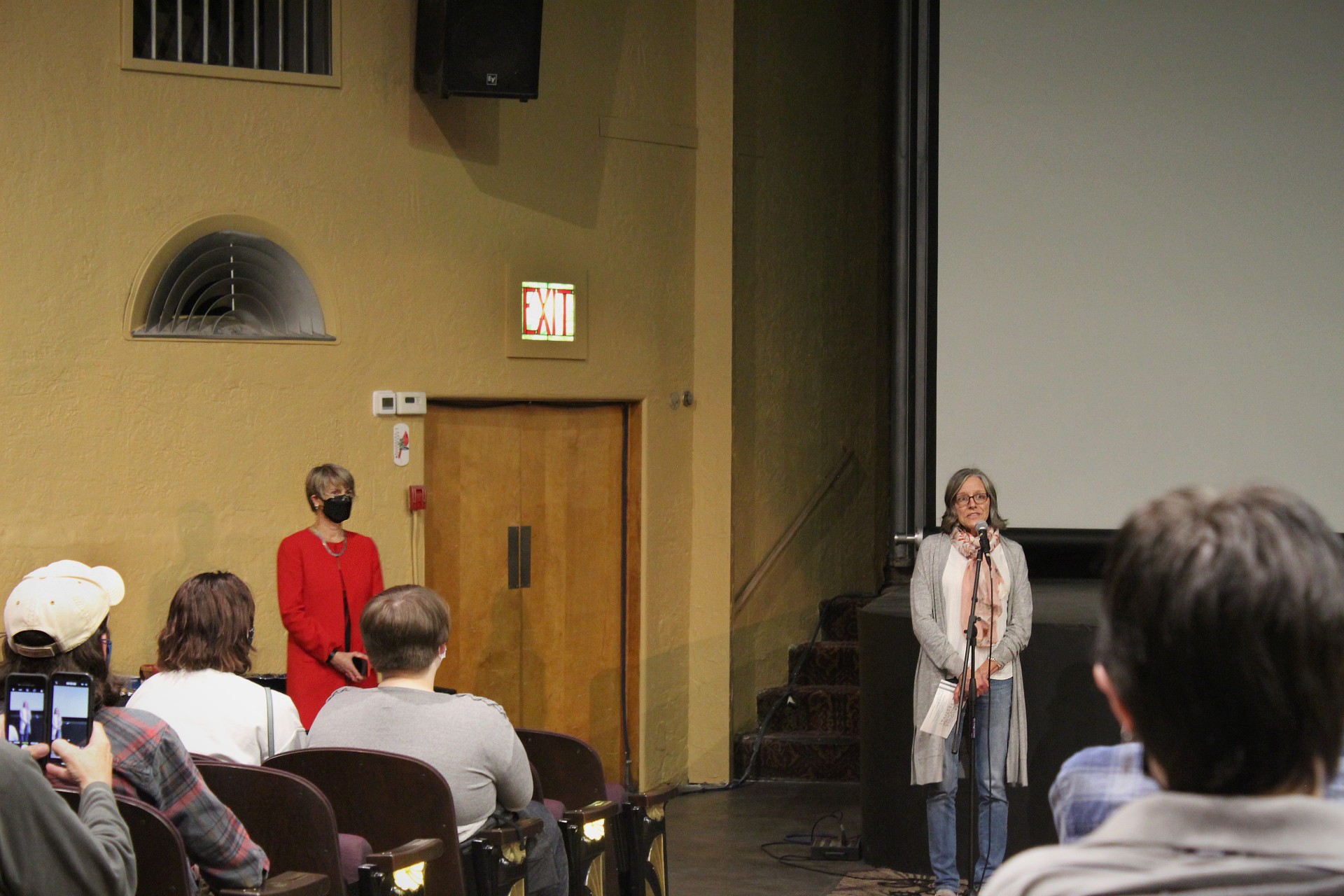 Sabine Davis speaking at a microphone.