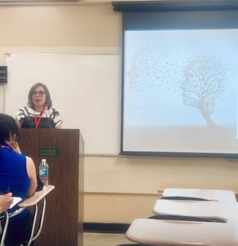Carmen R. Lugo-Lugo speaking at podium