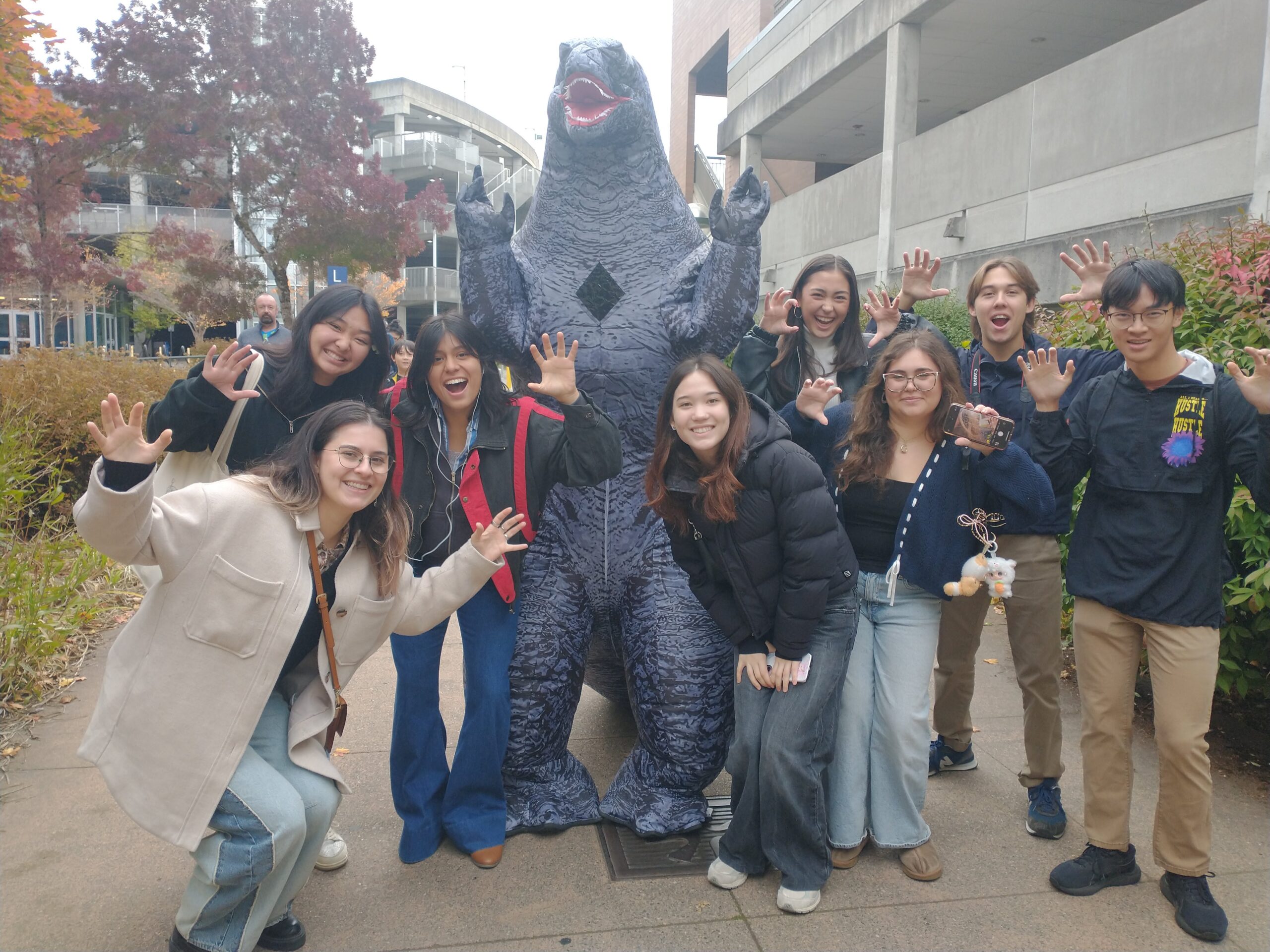 Students with a statue of Godzilla