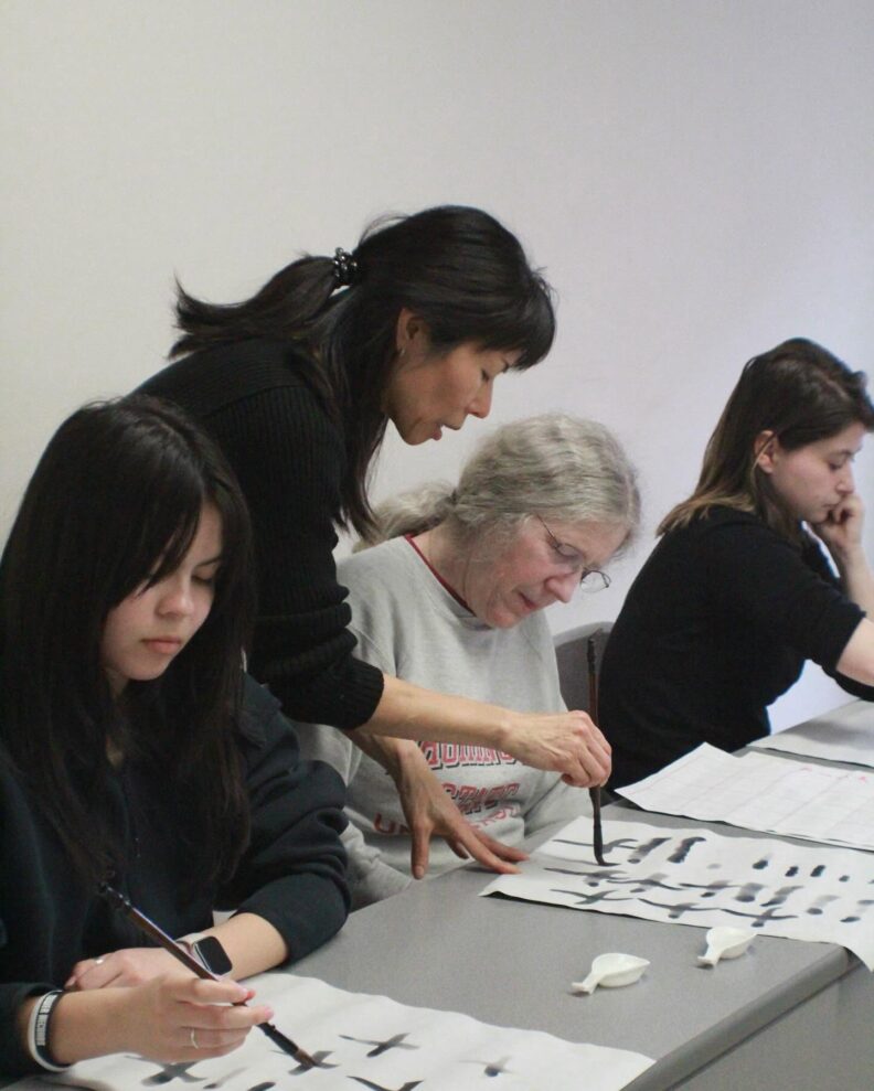 Japanese professor Kayo Niimi conducting a Japanese calligraphy workshop