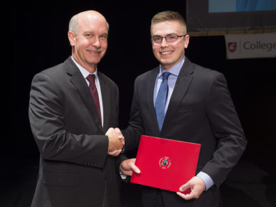 Joshua Garvison receives his award from Dean Daryll DeWald