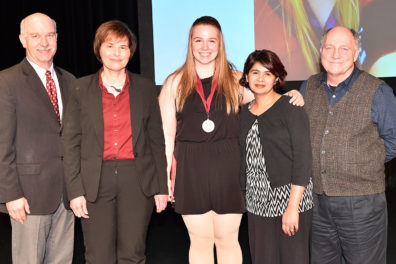 Anna Cole with dean and faculty upon receiving her Outstanding Senior medal