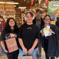 group of students holding merchandise