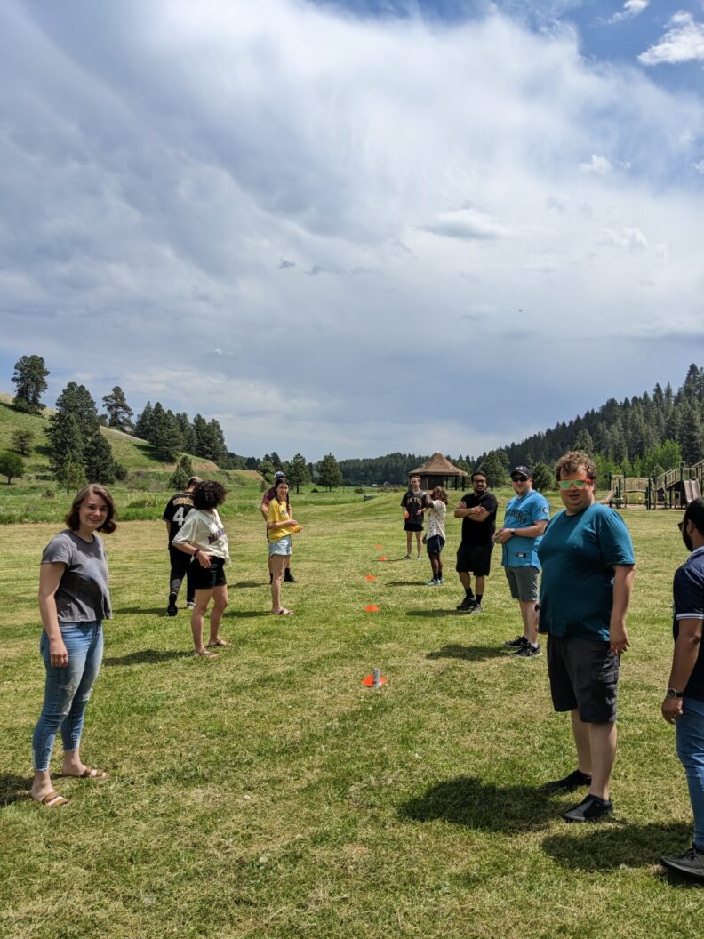 Chemistry students outside on a grassy lawn.
