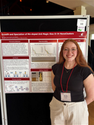 Molly Lauby stands next to research poster at SURCA.