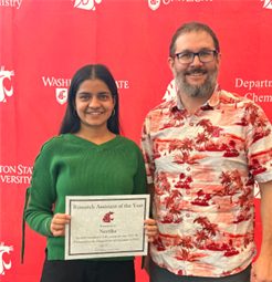 Neetika receiving an award.