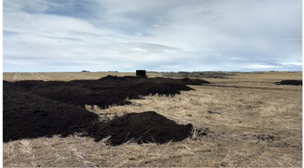 A photo of biosolids being stored in a field