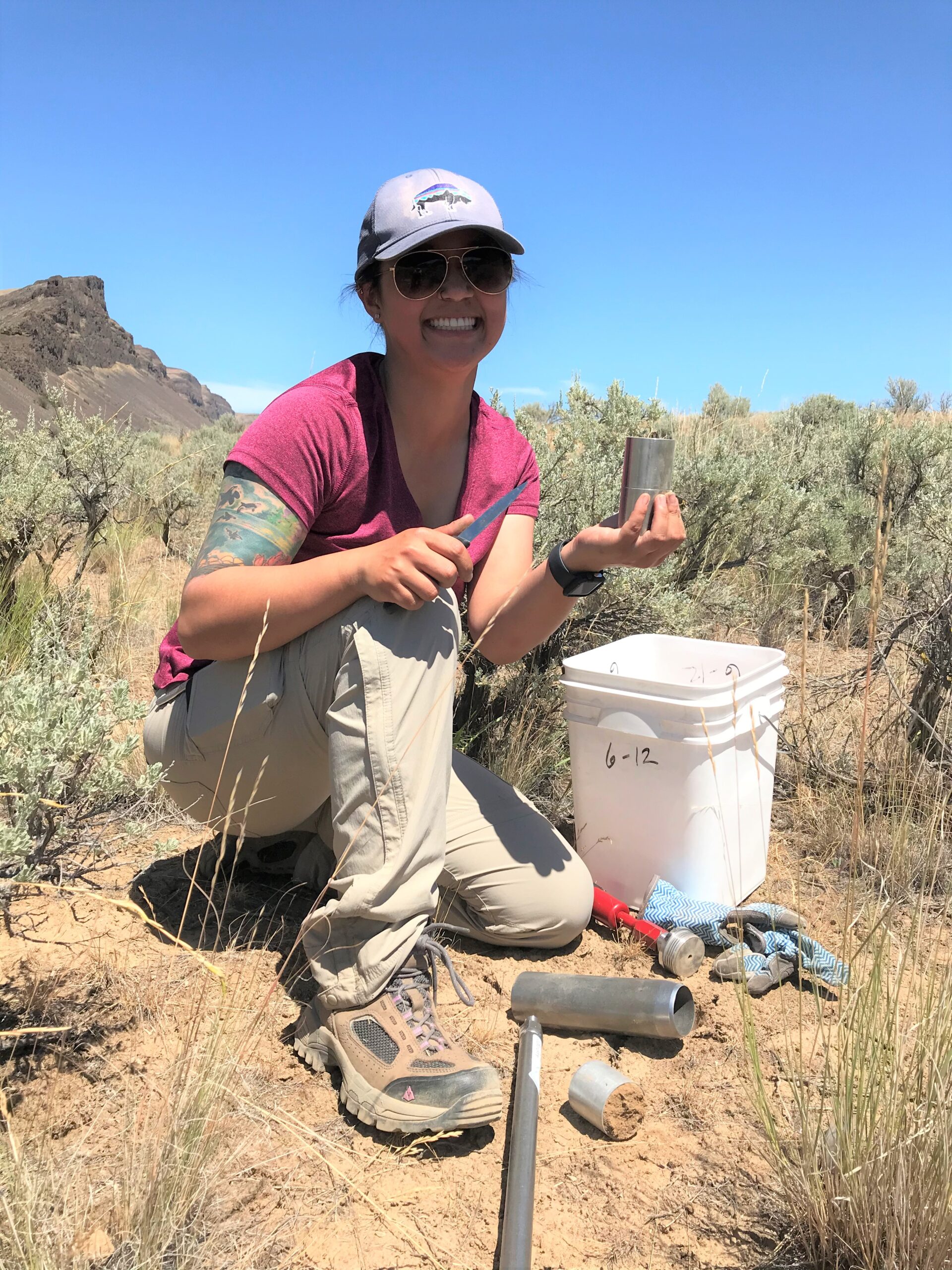Data scientist Jadey Ryan holding a bulk density soil sample