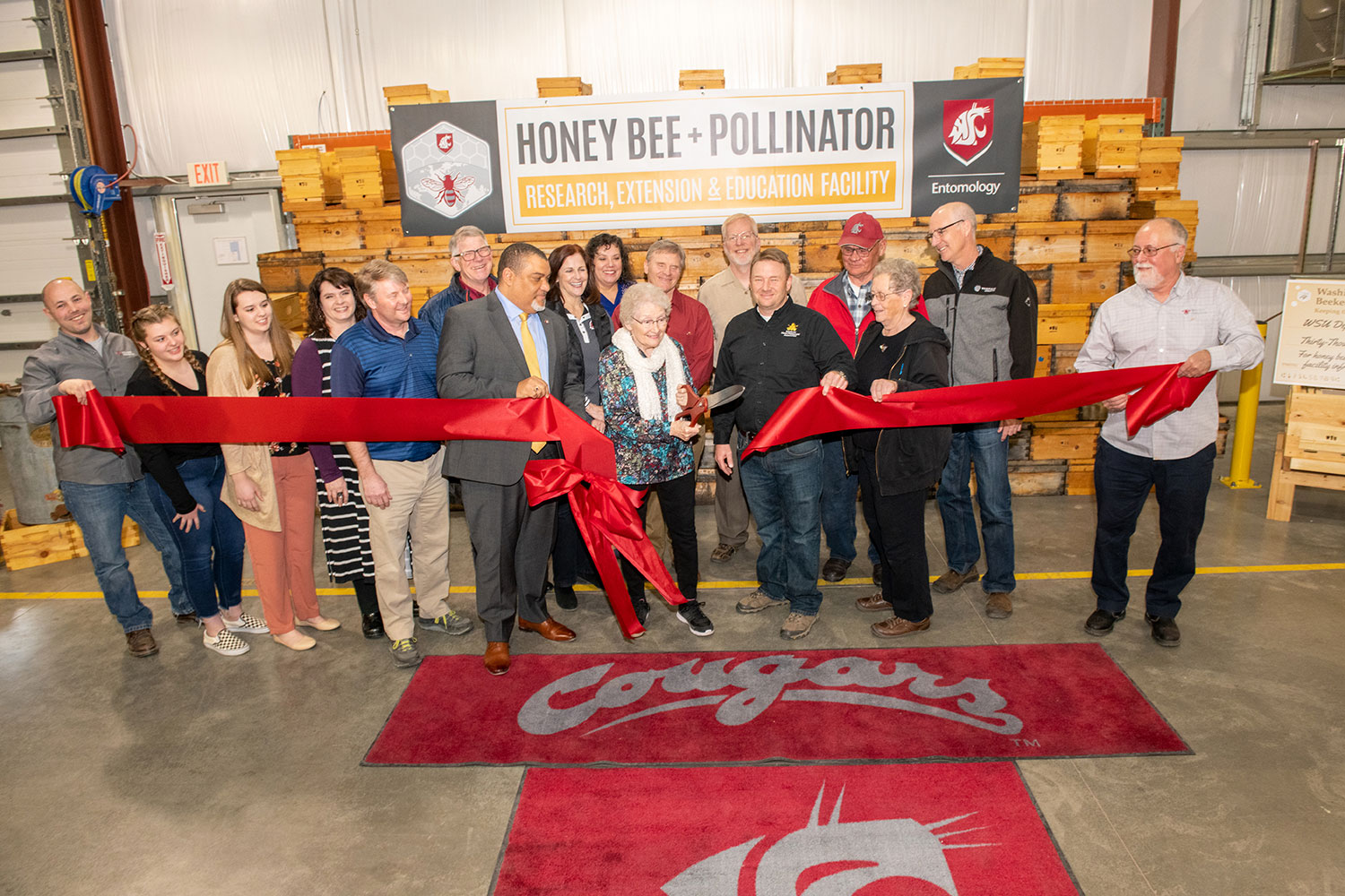 Cutting ribbon at Othello Honey Bee + Pollinator Facility opening celebration