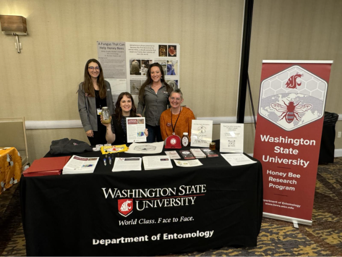 WSU Bee Program team members at their booth at the 2024 Annual Pacific Northwest Beekeeping Conference.