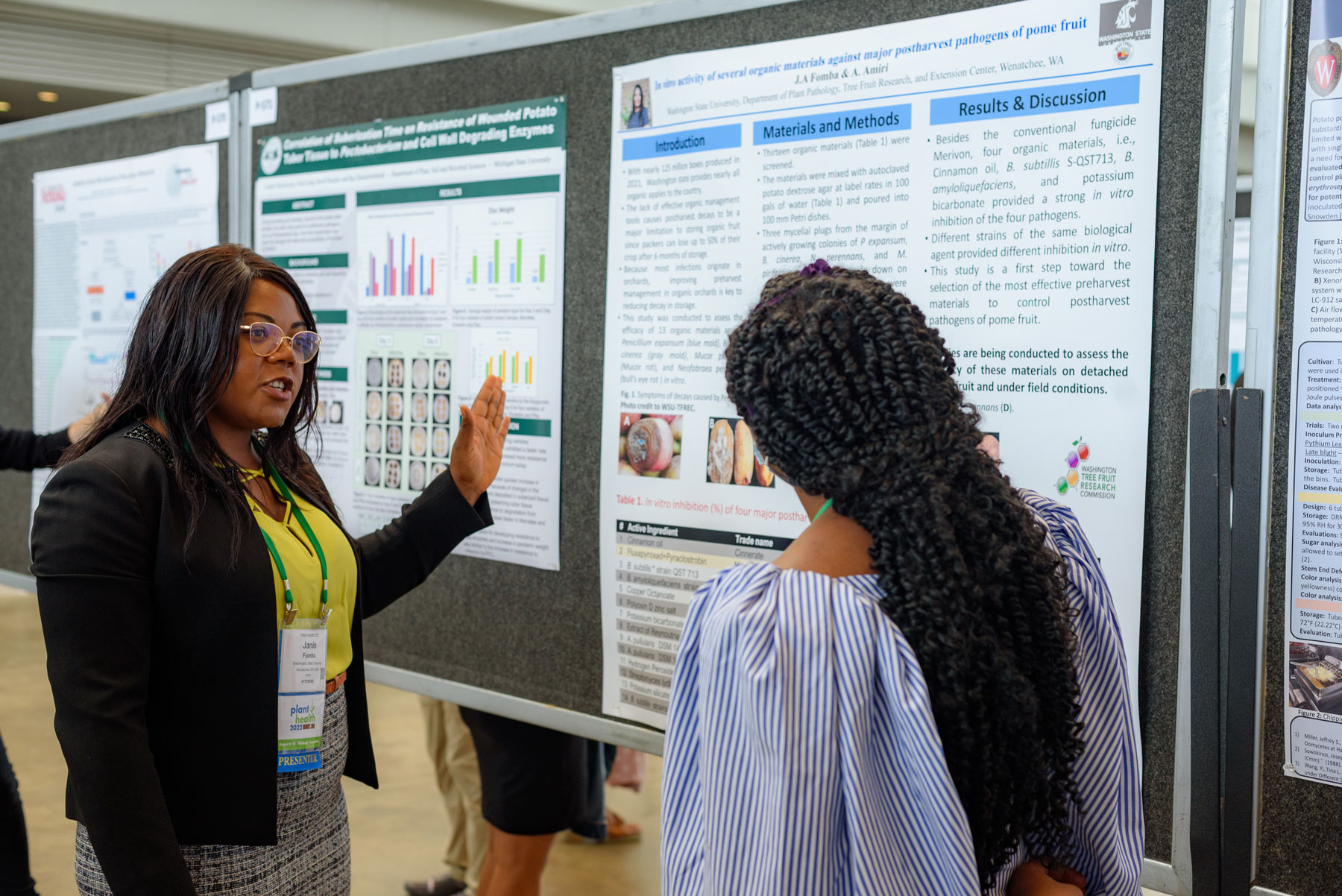 Graduate student presenting research poster