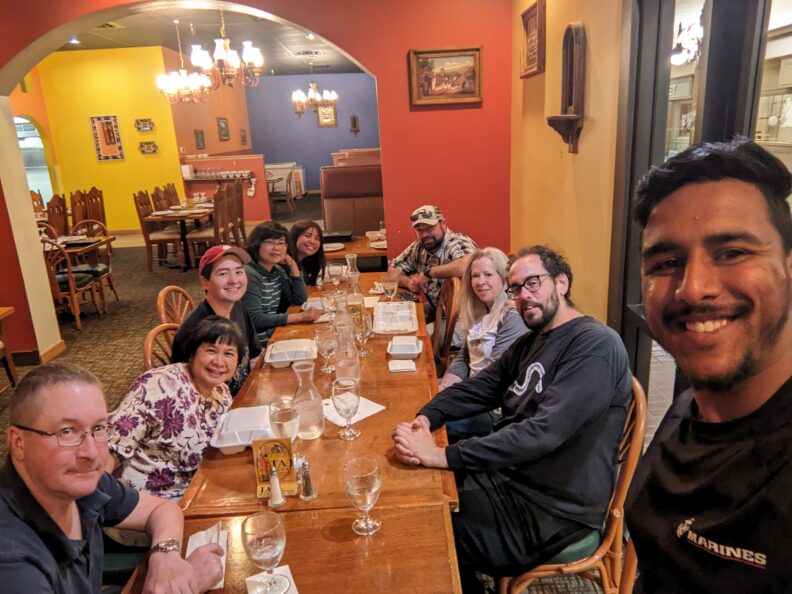Group of people sitting at table in a restaurant. 