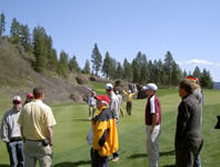 People standing on a golf course.