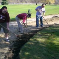 Men working in the dirt.
