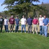 Group of men standing side by side.
