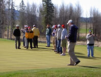 People walking on a golf course.