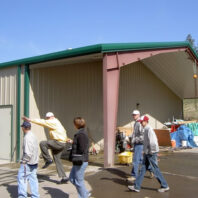 People walking by a building.