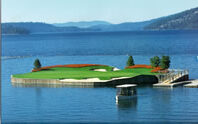 A golf green floating on a lake.