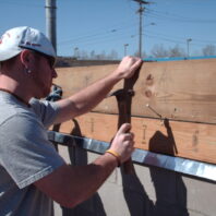 A man hammering a nail.