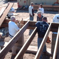 People building with wood.
