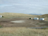 Field with construction equipment.