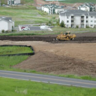 Plots with apartment buildings in the back.
