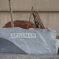 Spillman rock sign with shovels behind it.