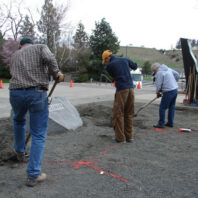People digging in gravel.
