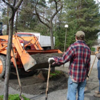 A person watching heavy equipment.