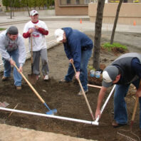 People working on an irrigation line.